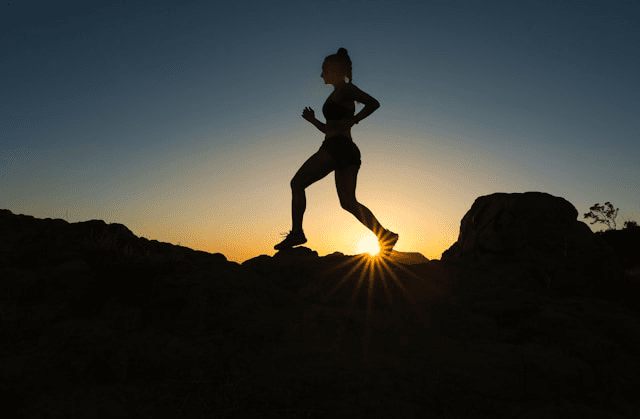 Woman running in the sunrise